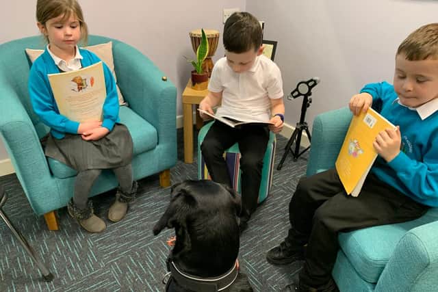 Margo listens to the children read