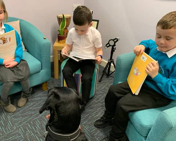 Margo listens to the children read