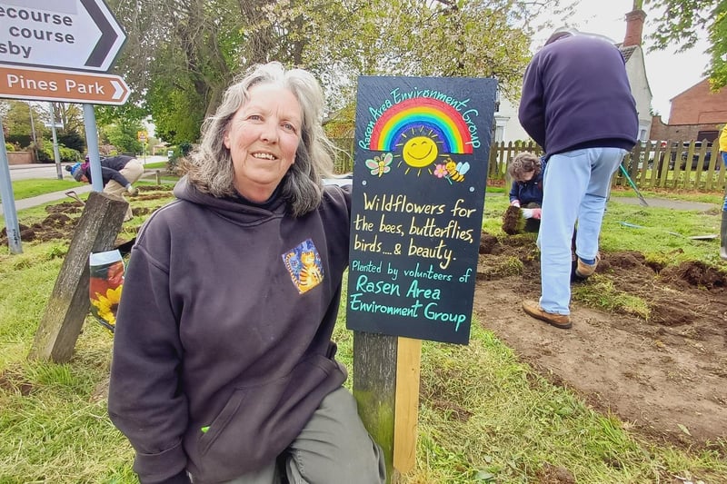 RAEG member Yvonne Horrocks with one of the signs she has made for the wildflower areas