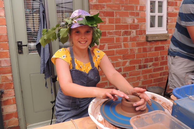 Lilly-Rose Early, 11, throws a pot at the arts and crafts workshops led by Ruth Burrows in navigation Yard.