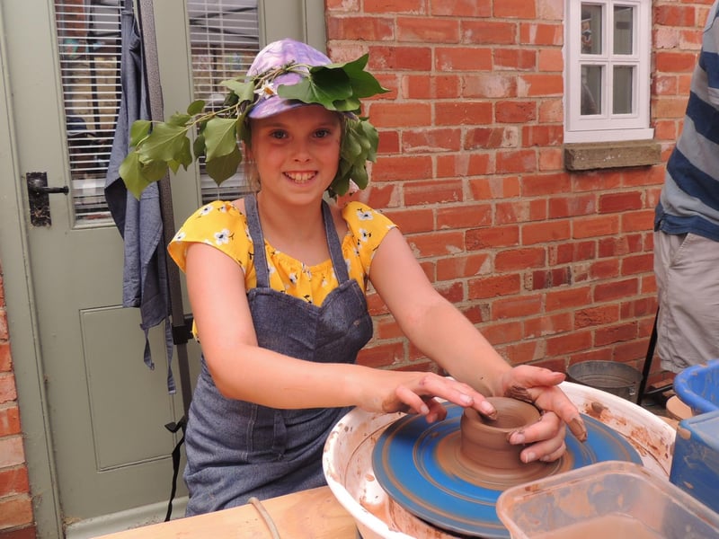 Lilly-Rose Early, 11, throws a pot at the arts and crafts workshops led by Ruth Burrows in navigation Yard.