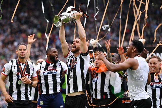Luke Waterfall of Grimsby Town lifts the Vanarama National League Final trophy after their sides victory during the Vanarama National League Final match between Solihull Moors and Grimsby Town at London Stadium. (Photo by Justin Setterfield/Getty Images)