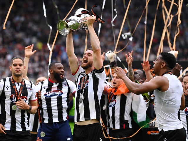 Luke Waterfall of Grimsby Town lifts the Vanarama National League Final trophy after their sides victory during the Vanarama National League Final match between Solihull Moors and Grimsby Town at London Stadium. (Photo by Justin Setterfield/Getty Images)