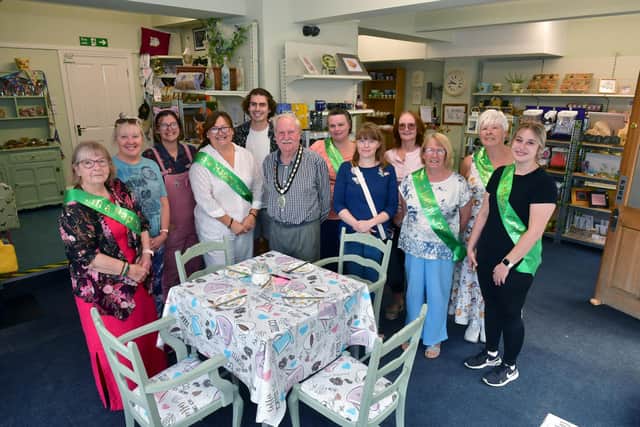 Inside the new Happy Crafters shop in Sleaford. L-R Pam, Marie, Jenni, Nic, Jake, Cllr Anthony Brand, Lindsay, Christina, Carole, Tracey, Bert and Laura.