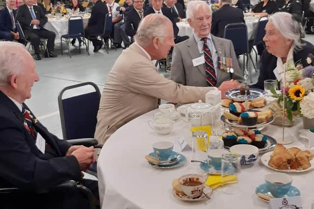 King Charles joins vetarans at a tea party in a hangar at RAF Coningsby.
