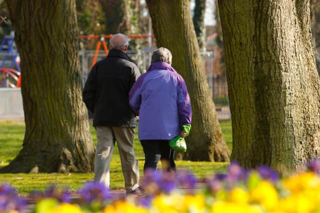 File photo dated 14/03/13 of a couple walking through a park as almost one in four people expect to work to the age of 70 or over and more than half admit they need to save more for retirement, according to a new report.