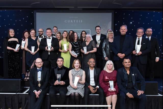 Jayne Bond is pictured with her award in the red dress. Left is Tej Singh, right is Vikas Baid of Arihant in Jaipur. Photo supplied by the National Association of Jewellers