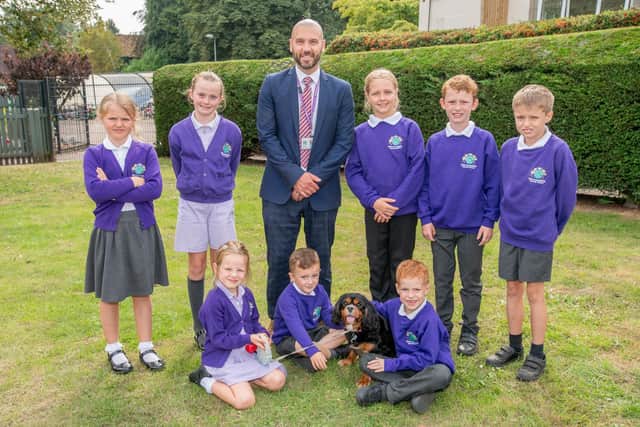 Horncastle primary headteacher Andrew Cook with Ruben the dog and pupils. Photo: John Aron Photography