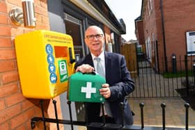 Sales Adviser, Ricky, with one of the new defibrillators installed by David Wilson Homes