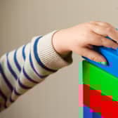 File photo dated 24/01/16 of a preschool age child playing with plastic building blocks. Parents have less time to read, play, and cook healthy meals with their children as a result of the cost-of-living crisis, according to a new poll. Issue date: Monday September 11, 2023.