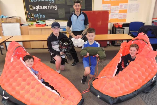 Cpl Allan Wighton from RAF Coningsby teaching about aircrew survival skills and equipment, with L-R Max, Ewan, Nathan and Sid.