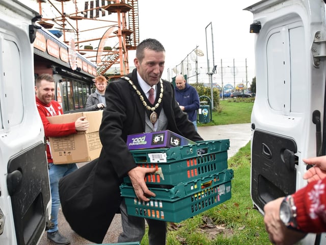 Mayor Coun Adrian Findley loading toys onto the van.