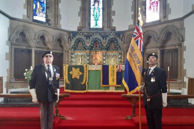 Former chairman of the Skegness branch of the Royal British Legion Les Constantine performs his final duty for the Skegness and Mablethorpe branch of the Burmar Star Association as their Standard is laid up. Kevin Woolley carries the new Standard of the Skegness branch of the Royal British Legion.