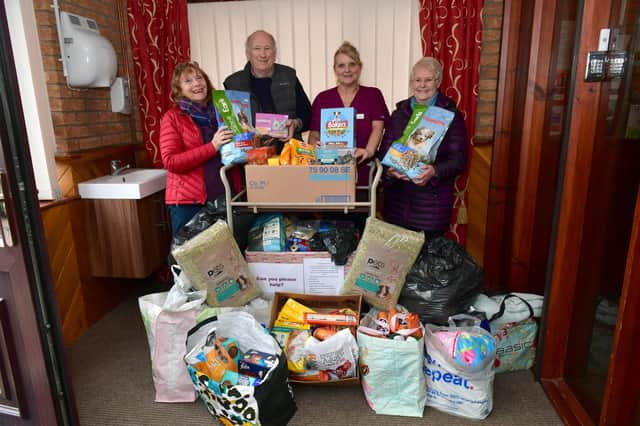 Jacquie Smedley and Bob Wayne of Ark Animal Rescue, recieving goods from Angie Clark and Moira Tasker of Tanglewood Care Home.