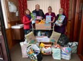 Jacquie Smedley and Bob Wayne of Ark Animal Rescue, recieving goods from Angie Clark and Moira Tasker of Tanglewood Care Home.