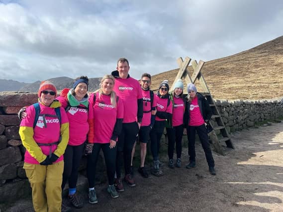 Eight supporters, smiling for a photo while doing One big Walk
