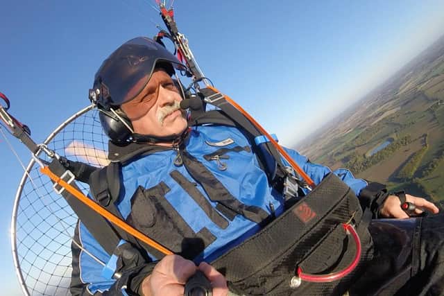Tim Taylor mid-flight with his paramotor.