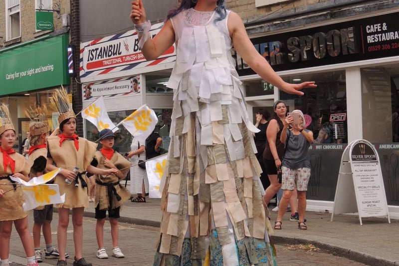 Colourful stiltwalker in the RiverLight finale parade.