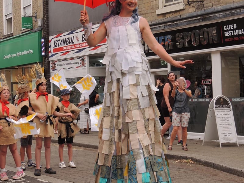 Colourful stiltwalker in the RiverLight finale parade.
