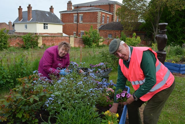 Ray and Mary Smart tending the beds on the station approach