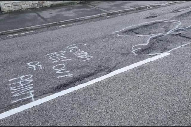 Some of the witty graffiti which highlighted the state of Ermine Street in Ancaster, prior to the repair works.