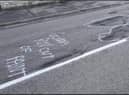 Some of the witty graffiti which highlighted the state of Ermine Street in Ancaster, prior to the repair works.