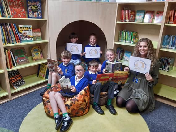 Grimoldby primary schoo's reading ambassadors, from left back: Orla Ranshaw, 6, and Emily Humphries, 8.
Front: George Buckley, 6, Scarlett Carter, 8, Artemas Wood, 7, and Annabelle Martin, 8, with RfP lead Rebecca Oliver.