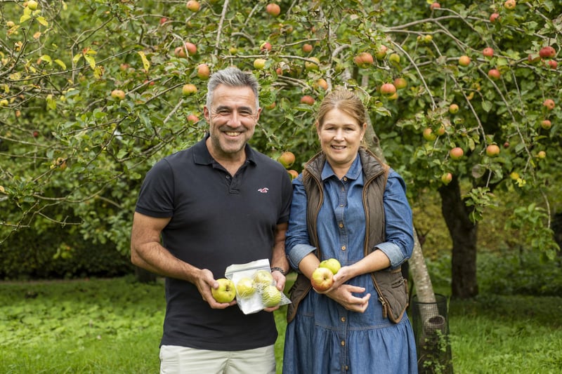 Teresa Hake and David Hake in the orchard.