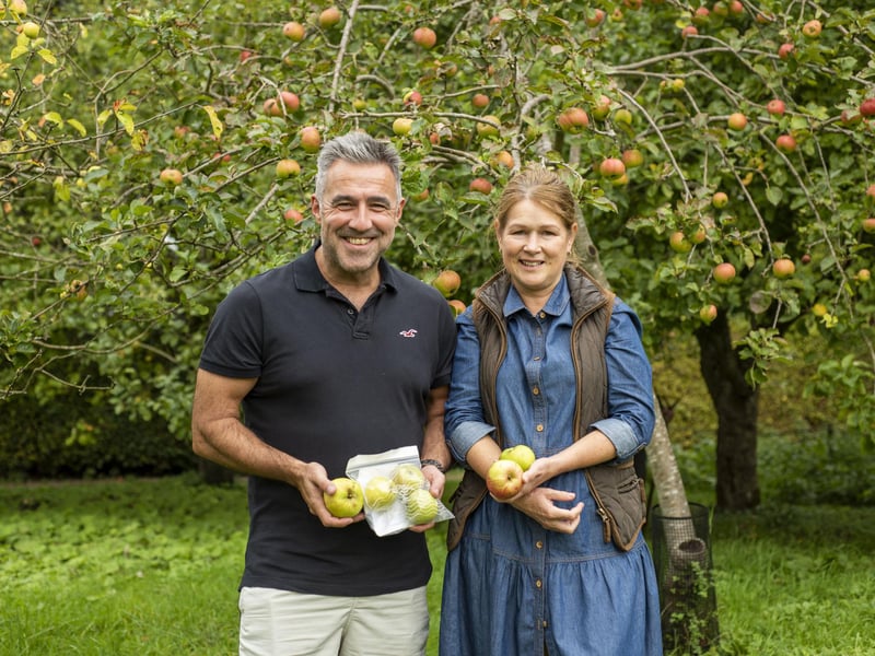 Teresa Hake and David Hake in the orchard.