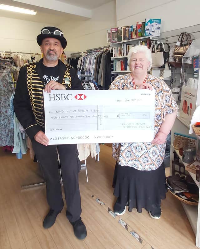 FLOSS founder Captain Skirmish presents the cheque to Horncastle's Red Cross.
