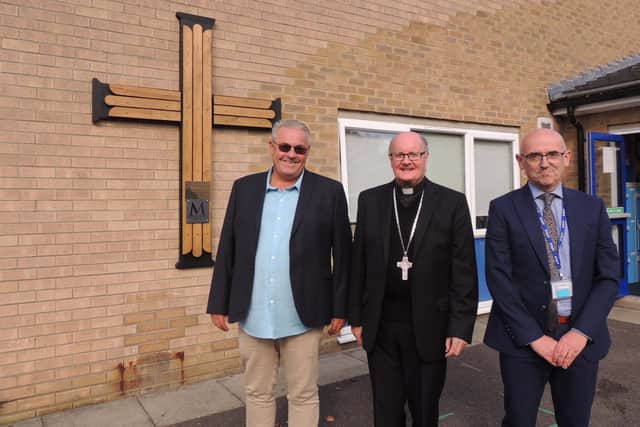 Unveiling and blessing the new cross. From left - Wayne Chawner who created the cross, Rt Rev Patrick Joseph McKinney - Catholic Bishop of Nottingham, and Paul Tibble - headteacher of Our Lady of Good Counsel RC Primary school in Sleaford.