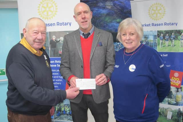 Andy's, St Andrews Hospice rep. receives donation