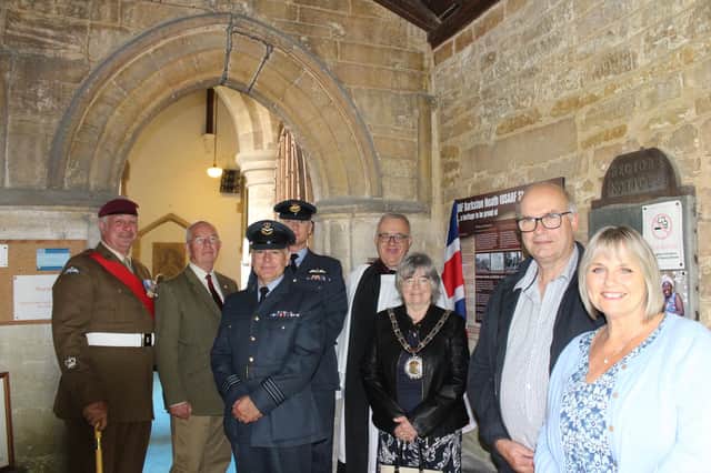 Liz Parkin and Peter Motley (front) with assembled guests at the unveiling, from left, W/O Ian Chick, 4th Battalion Parachute Regiment, Coun Dixon-Warren, Flt Lt Michael Frankel, RAF Barkston Heath, Sqn Ldr Michael Chambers, RAF Barkston Heath, Rev Stuart Hadley and Coun Gloria Johnson. Photo: SKDC