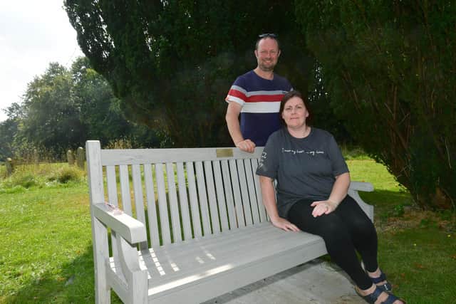 Hayley and Stephen Ormond pictured with the memorial bench for their two stillbirth children in Louth Cemetary.