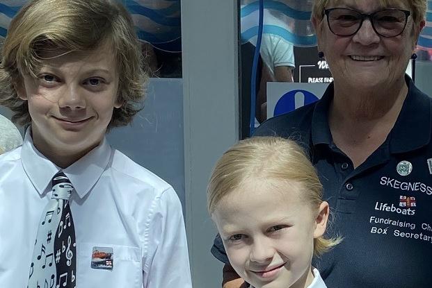 Piano marathon brothers Elijah and Aaron with Mrs Mairi Perry of the Skegness RNLI.
