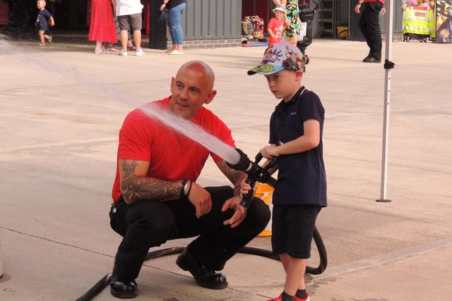 Jackson Wood, five, of Sleaford has a go with the hose with firefighter Stewart Hill.