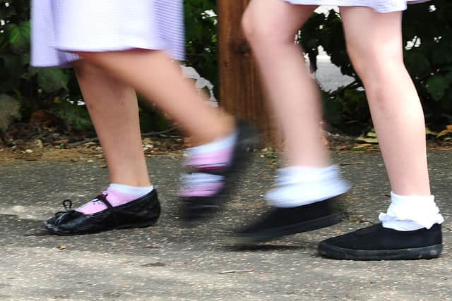 File photo dated 15/07/14 of school girls walking to school. Nearly a third (31%) of parents and carers do not talk to their children openly about money, according to research for a UK Government-backed body. The findings were released by MoneyHelper to mark Talk Money Week (November 8 to 12). Issue date: Monday November 8, 2021.