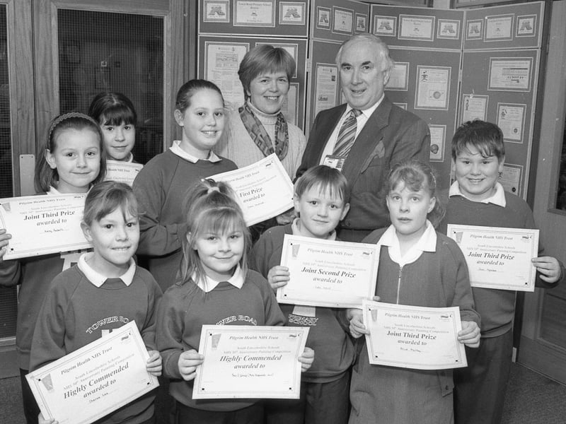 Talented young artists at Boston's Tower Road posing for the camera. The youngsters had taken part in a painting competition to celebrate the NHS's 50th anniversary. Emma Woodcock took the top title and collected a £10 book token from Pilgrim NHS Trust chairman Peter Jordan. In second place were Hannah Shaheen and Luke Ward, who won a £5 book token each. Book tokens worth £3 went to third-placed Kerry Roberts, Sam Oglesbee and Alice Maltby, while Laura Hallet, Kimberley Brown, Cally Johnson, Sarah Peck, Sheree Lee and a group entry from Year Three pupils were highly commended. Mr Jordan is pictured with some of the entrants and teacher Liz Harness, who organised the art work.