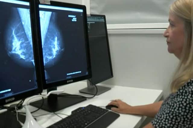 Viewing a mammorgram on screen.