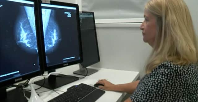 Viewing a mammorgram on screen.