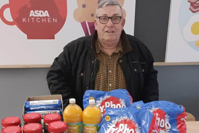 Volunteer John Baxter receiving 1,320 teabags, 6 jars of coffee, biscuits, and squash for Old Leake Community Centre's Warm Space.