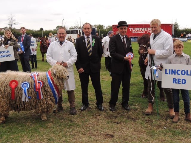 Presentation time - from left - male champion winner Ian Fairburn of Market Rasen and his ram from the Risby Flock; guest Andrew Read, director of the Lincolnshire Show, show chairman Charles Pinchbeck, champion Lincoln Red cattle breeder Martin Clough of Halton Holegate with son Matthew.