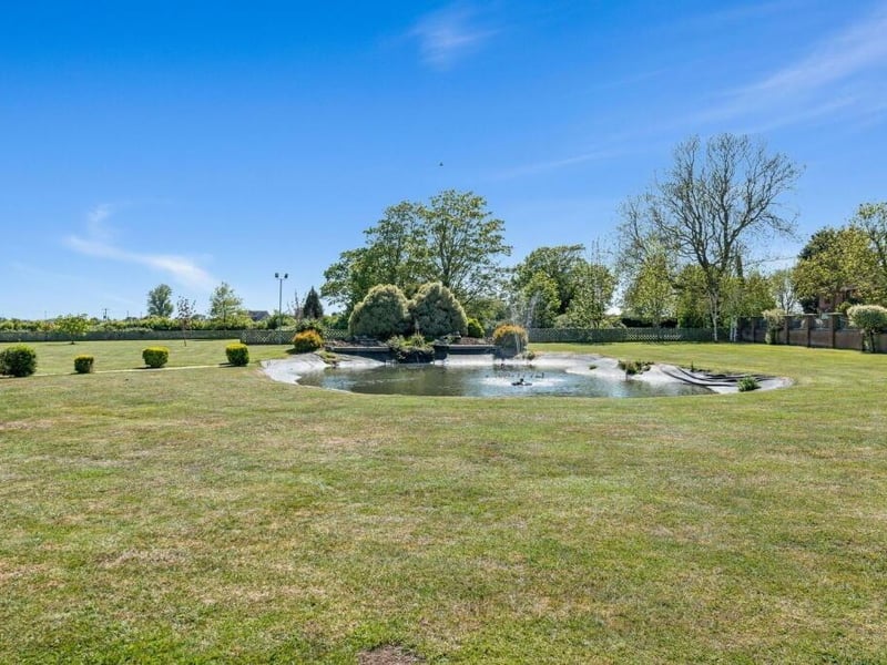 The ornamental pond with central fountain and two waterfalls.