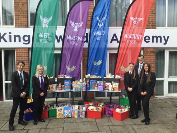 Students and Mark Wilkinson, Head of School at KEVI, with their harvest festival donations.