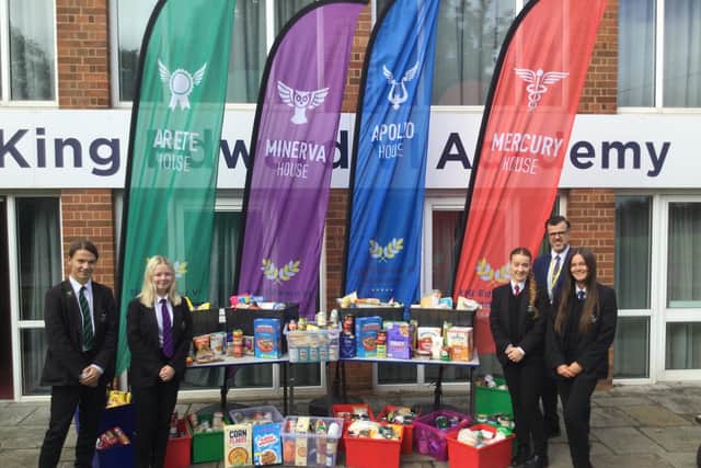 Students and Mark Wilkinson, Head of School at KEVI, with their harvest festival donations.