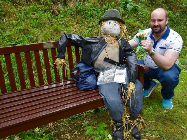 Steve Tarling - Heritage Learning Officer for the Church Conservation Trust with one of the scarecrows linked to the village festival. Photo: David Dawson