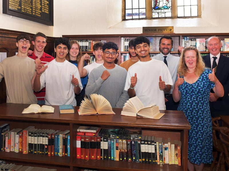 Students with Head of Sixth Form Steve Barker (third from right), A-level teacher Christine Abrams (second from right), and headteacher John McHenry (far right).