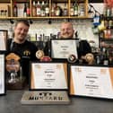 Munyard Brewery owner Oliver Munyard (left) and apprentice Jack Midgley with the awards won at the beer festival.