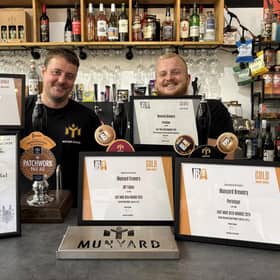 Munyard Brewery owner Oliver Munyard (left) and apprentice Jack Midgley with the awards won at the beer festival.