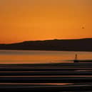 The sun sets over Camber Sands.